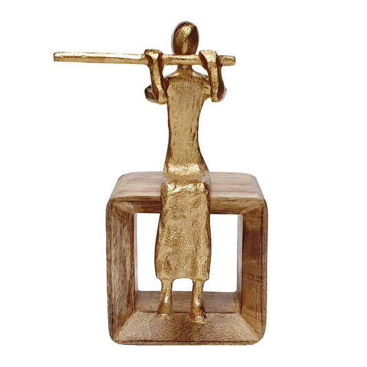 Golden musician figure seated
